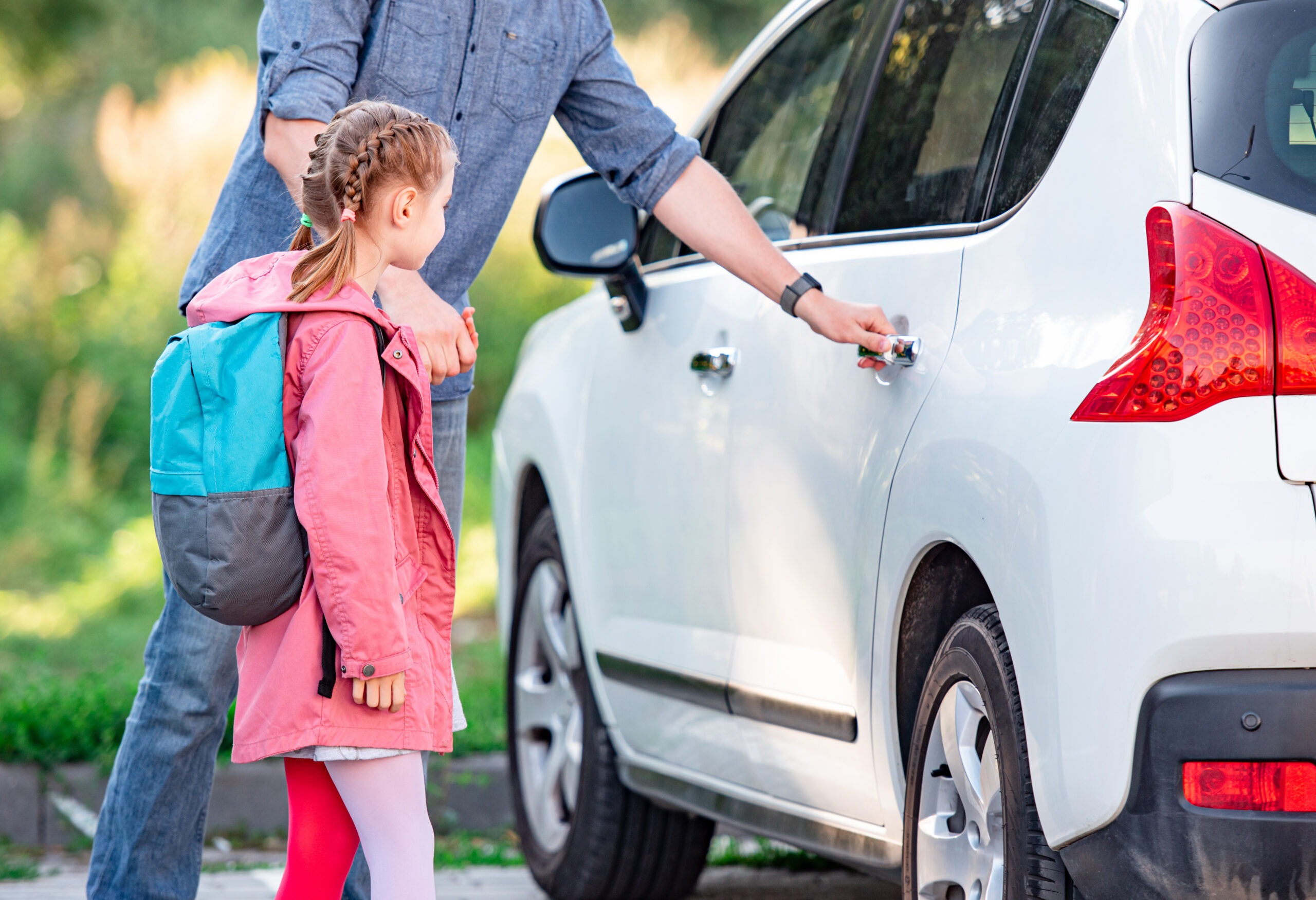 Parent and child getting into their vehicle for back-to-school driving in Kingsville Ontario